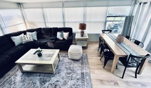 Large add-a-room with dining table and smart flat screen tv.  All windows around