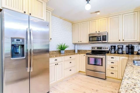 Spacious kitchen opens up to the main living room. There is a built-in banquet as well as a large dining table.