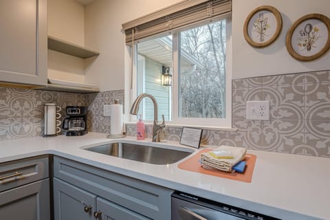 Rustic wood accents, and vintage-inspired fixtures create the perfect farmhouse ambiance in the well-stocked  kitchen.