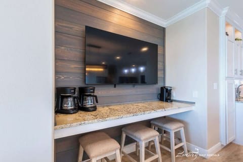 TV over coffee bar by kitchen