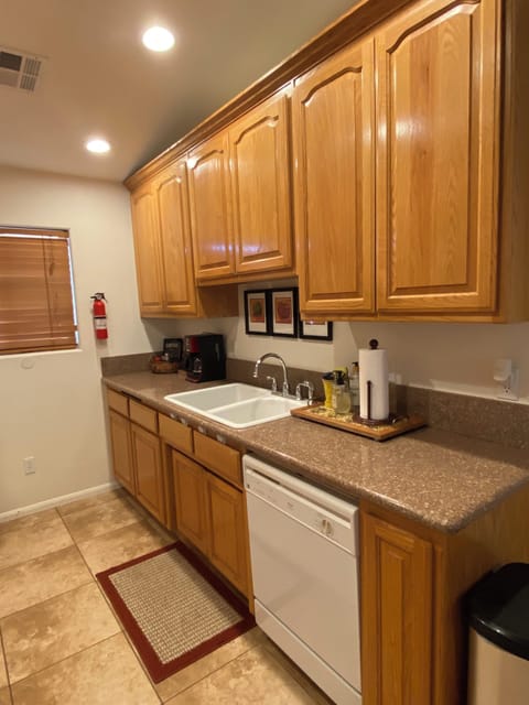 The kitchen is full stocked, pots, pans, dishes, utensils, serving wear and more