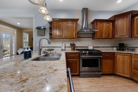 Fully equipped kitchen with ample counter space, sleek stainless steel appliances, and an open layout just off the living room—perfect for cooking and entertaining!