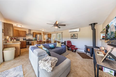 Open floor plan with a 55 in smart tv, and a wood stove for those cold nights!
