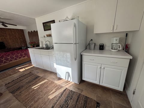 Kitchen area with coffee pot and refrigerator