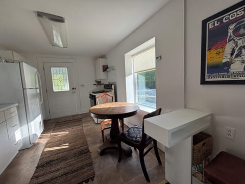 Computer and charging station with a stool and plug in.
