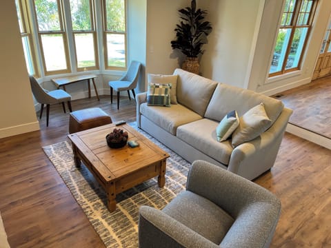 Living room with window reading nook and gas fire place.