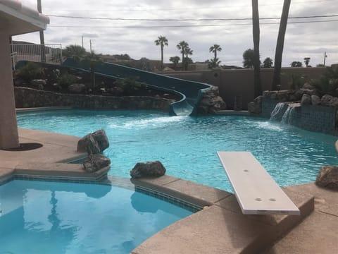 Big PRIVATE RESORT style pool with professional waterslide, spa, and waterfall.