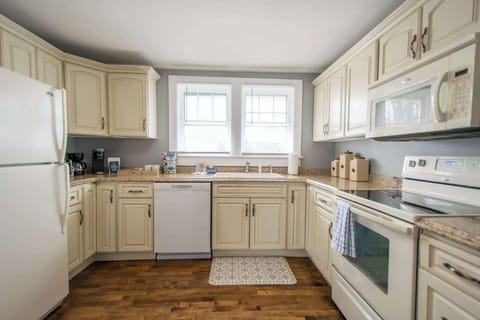 Kitchen stocked with pots and pans, utensils, cooking essentials.