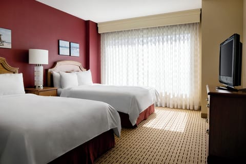 Unwind in crisp linens and a bright, restful bedroom.