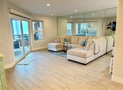 Large, sunlight filled living room, cozy beachy vibes, automatic blackout blinds