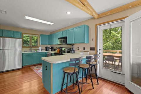 Bright kitchen with stainless appliances, open layout & mountain charm.