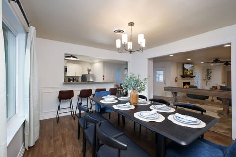  Enjoy meals together in our spacious dining area with seating for 8! The large island with high seating creates the perfect space to gather, seamlessly connecting the kitchen and dining room. 