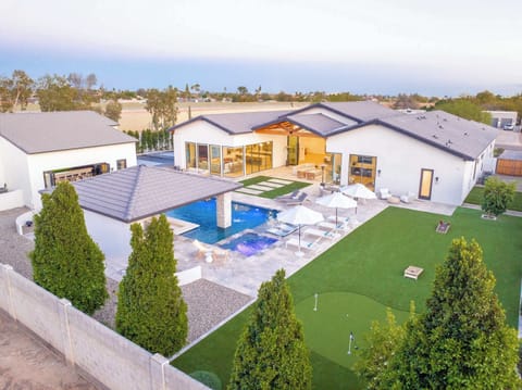 Expansive Backyard – Aerial view of the estate featuring pool, cabana, putting green, and games for everyone.