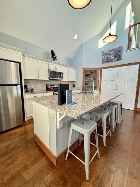 Envisage great room: Kitchen island and closet to laundry depicted.