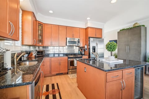 Your gourmet kitchen awaits with granite counters, stainless appliances, and warm wood cabinets—perfect for preparing memorable meals.