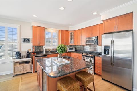 Your gourmet kitchen awaits with granite counters, stainless appliances, and a convenient breakfast bar—perfect for cooking memorable meals together.
