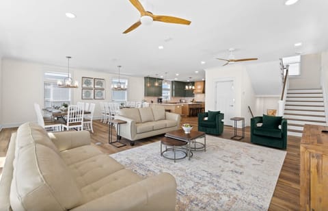 Relax in this bright open-concept living space where modern comfort meets stylish design. You'll love gathering with family on plush sofas.