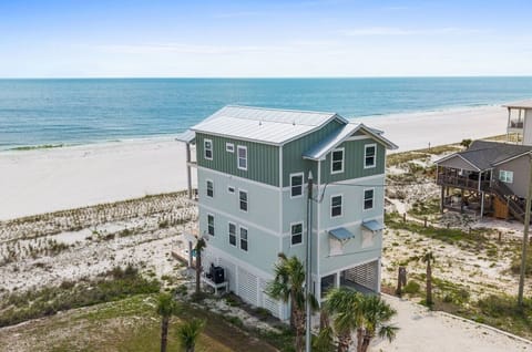 This stunning beachfront property sits directly on pristine white sand, offering unobstructed Gulf views and immediate beach access from your private coastal retreat.