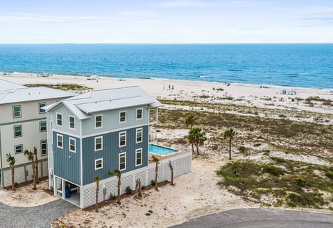 Beachfront property positioned on sandy coastline with a private pool and direct beach access. The property features modern construction in a serene coastal setting.