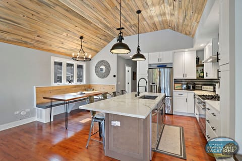 Fully equipped kitchen, breakfast bar seating for 4, open to dining room.