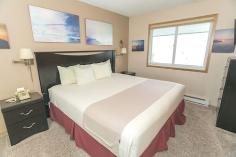 Settle into a cozy king bed with soft, plush pillows.