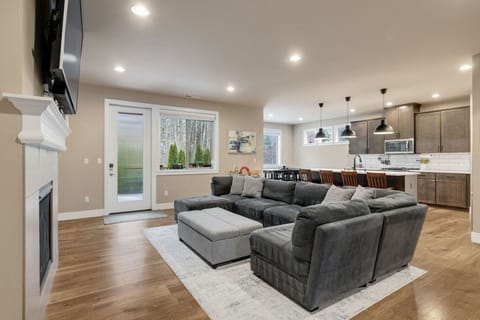 Unwind in style! The spacious living room features a cozy fireplace and an oversized sectional for ultimate relaxation.
