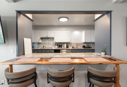 Enjoy casual meals and conversation at this inviting kitchen counter with a view of the modern kitchen.