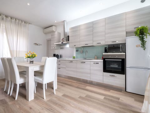 Furniture, Kitchen, Kitchen Appliance, Interior Design, Flooring, Countertop, Cabinetry, Floor, Major Appliance, Wood