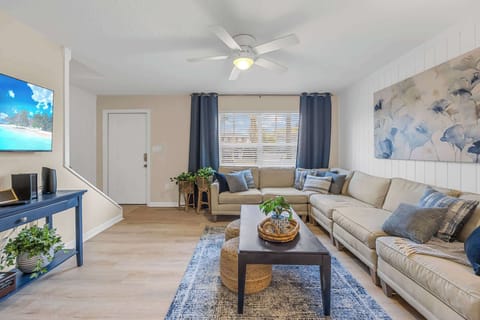 Relax in this cozy living room with a large sectional sofa and natural light from the window.