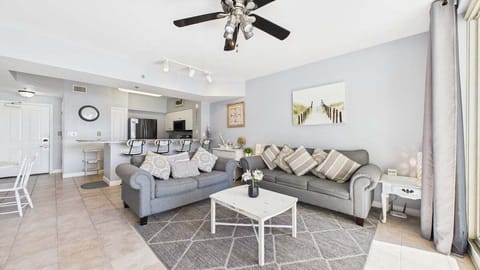 Open concept living area with sleeper sofa TV and balcony access
