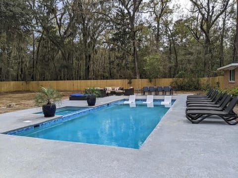 Musical Chairs - Enjoy the pool with comfortable lounge seating, outdoor couches, and a spacious dining table, perfect for relaxation or entertaining friends and family.