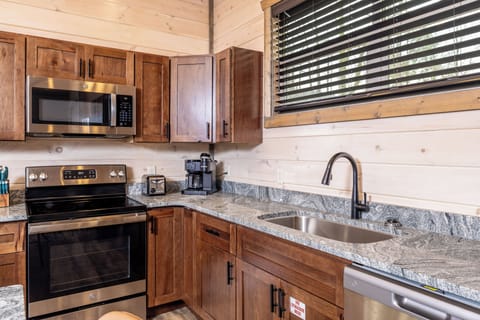 Fully stocked kitchen with stainless appliances, granite tops & coffee bar