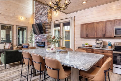 Modern kitchen with island seating, fireplace views & full cooking essentials