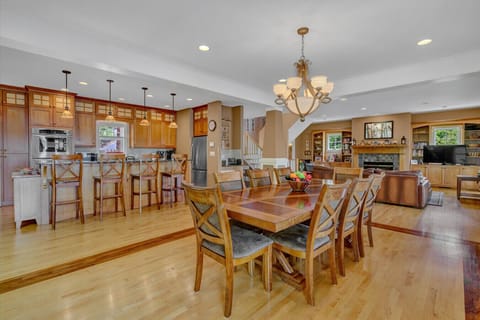 The dining area’s elegant table and ambient lighting create the perfect setting for memorable meal.
