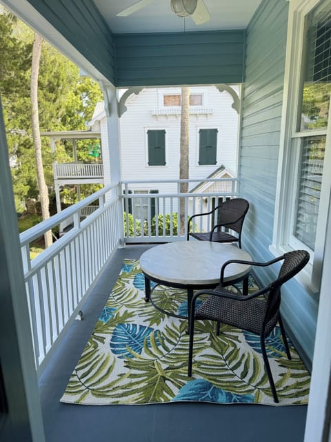 Lovely patio attached to family room overlooking backyard and Palm Row