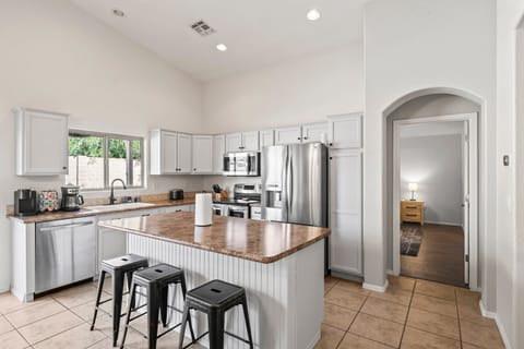Kitchen is stocked with all the basics - dishes, cups, pots, pans.