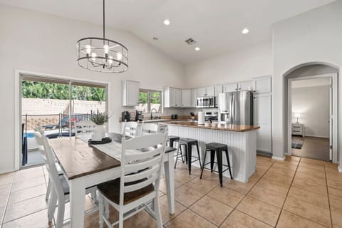 Table seats 6, plus 3 barstools and additional table and seating on the patio.