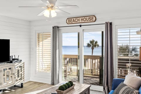 Wake up to ocean waves from your cozy living room, where coastal comfort meets stunning sea views through expansive windows.