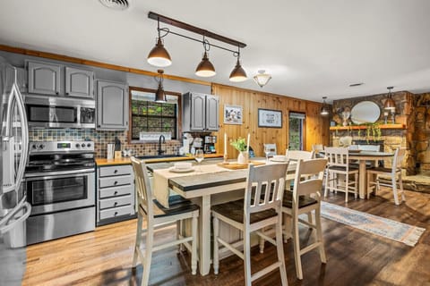 Cook up a feast in this rustic-modern kitchen with stainless steel appliances and farmhouse-style dining.