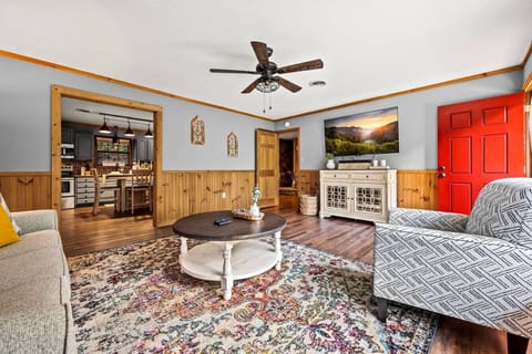The beautifully designed living room with a large Smart TV, plenty of comfortable seating and lots of natural light.