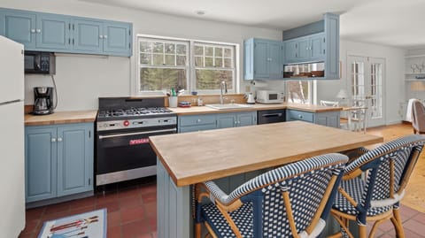 - Kitchen with center island and modern design   - Blue cabinetry paired with wooden accents   - Fully stocked for cooking family style meals