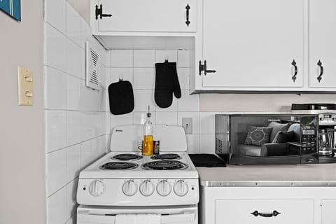 Kitchen includes cookware, bakeware, utensils, spices, and avocado oil.