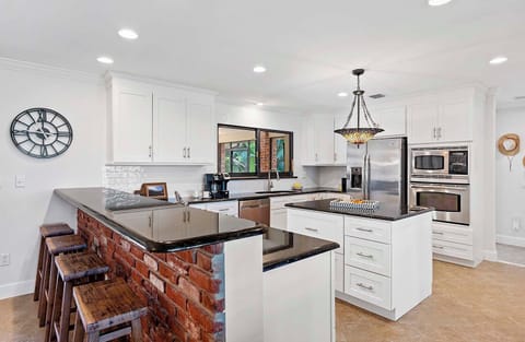 Kitchen Offers Gas Stove, Island and Bar Counters