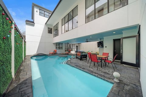 Step into your private outdoor oasis w/a heated pool featuring a built-in table & stools. Relax on the covered patio w/a TV, outdoor dining, ping pong, cornhole, and lounge chairs—perfect for soaking up the sun and enjoying endless entertainment
