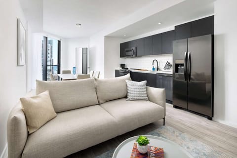 Lounge comfortably in bright open-plan space with modern kitchen.