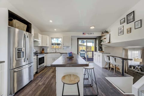 Bright and stylish kitchen with stainless steel appliances, a large island, and seamless access to the outdoor deck!