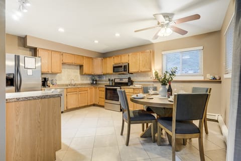 A kitchen designed for gathering with stainless steel appliances and ample counter space.