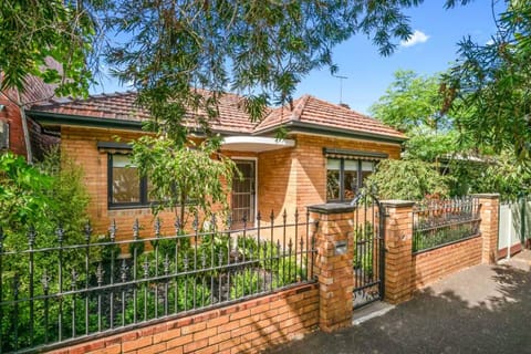 FRONT: Wide, double fronted home with three bedrooms (Queen, Queen Twin Single) in a tree lined street. Parking directly out front.