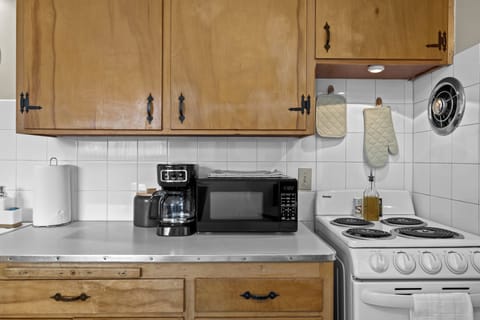 Kitchen includes cookware, bakeware, utensils, spices, and avocado oil.