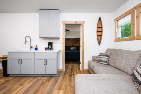 Living Room: Sunlit space with plush seating and scenic woodland views for ultimate relaxation!